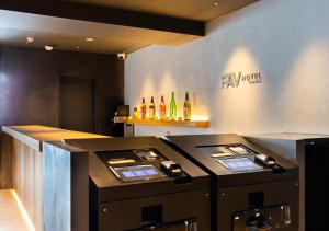 a kitchen with a counter with alcohol bottles on the wall at fav Hida Takayama in Takayama