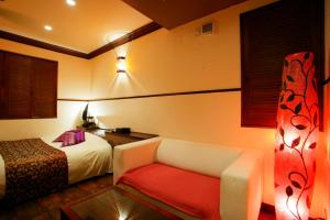 Postel nebo postele na pokoji v ubytování HOTEL CHECK INN BALI adult only