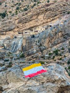 a flag sitting on the side of a mountain at the suwgra-Al-Jabal Al-Akdar in Sūkirah