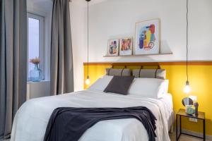 Un dormitorio con una gran cama blanca y una ventana en Lovely nest in the city center Fast WiFi en Trieste