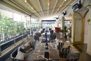a restaurant with long tables and chairs and plants at A11 HOTEL Exclusive in Istanbul