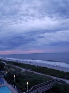 a view of a beach with people walking on the sand at Ocean Star Hotel in Myrtle Beach