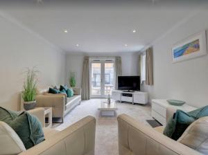 a large living room with couches and a tv at Priory House; sleeps 6-20 in Goodleigh +35 photos