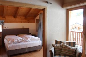 a bedroom with a bed and a sliding glass door at ClubHotel Hinterthal Am FlorySee 12 in Hinterthal