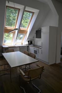 a kitchen with a table and chairs in a room at Schrotboden in Geschendorf