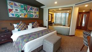 a hotel room with a bed and a bath tub at Sarova Panafric Hotel in Nairobi