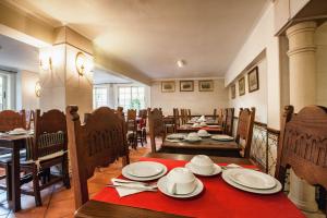 a dining room with a table and chairs with plates at Villa Rosa in Lagos