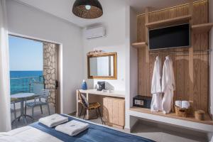 Dormitorio con cama y escritorio con vistas al océano en Enorme Serenity Spritz - Adults Only en Hersonissos