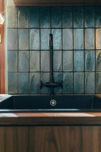 a kitchen sink with a faucet on a counter at Papagayo, appartement halles et côte des basques in Biarritz