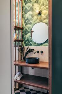 a bathroom with a sink and a mirror at Papagayo, appartement halles et côte des basques in Biarritz