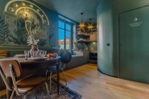 a kitchen with a table and a dining room at Papagayo, appartement halles et côte des basques in Biarritz +29 photos