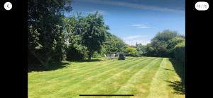 a person standing in the middle of a grass field at The cottage at number 5 in Selsey