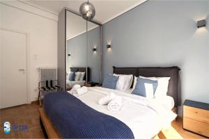 a bedroom with a large bed and a mirror at The Spiritual Athens Apartment in Athens