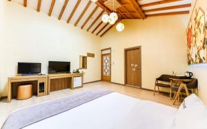 ein Schlafzimmer mit einem Bett, einem TV und einem Sofa in der Unterkunft Jeonju Hanok Hotel Kung in Jeonju