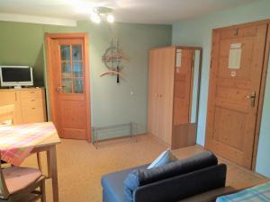 a living room with a blue couch and a table at Pension/FeWo E. Tschernach in Treuchtlingen