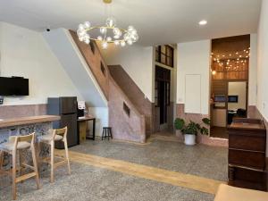 uma cozinha em plano aberto e sala de estar com uma escadaria em Green Only Homestay em Tainan