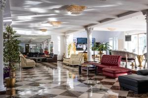 a lobby with couches and chairs and a table at Vnukovo Village Hotel & Spa in Kartmazovo