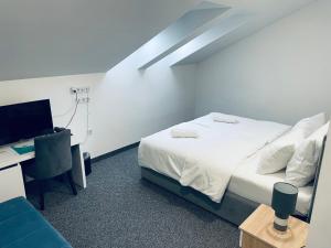 a bedroom with a bed and a desk with a computer at Hotel Vezir Palace in Travnik +74 photos