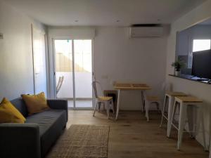 a living room with a couch and a table at Feel Welcome Barcelona Smart flat in Cornellà de Llobregat
