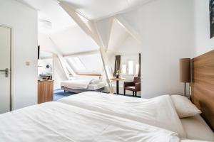 Een bed of bedden in een kamer bij Hotel Hulst