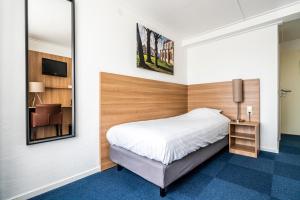 Een bed of bedden in een kamer bij Hotel Hulst