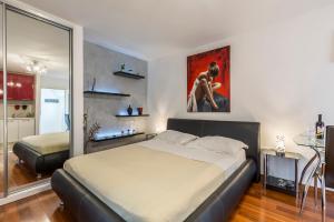 a bedroom with a bed and a painting on the wall at ToMaDi Residence in Split