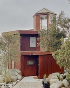 ein Holzgebäude mit einem Turm darüber in der Unterkunft Kinoie Mornington - OCEANVIEW in Mount Martha