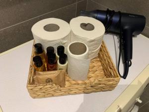 a basket on a counter with toilet paper and bottles at Dormi Tranquillo in Bologna