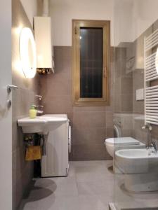 a bathroom with a sink and a toilet at Dormi Tranquillo in Bologna