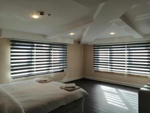 1 dormitorio con 2 ventanas grandes y 1 cama en Opatija Hotel, en Estambul