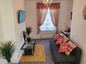 a living room with a couch and a window at king Bed Premium luxury suite + Free Parking + Free Fast WiFi in Morley