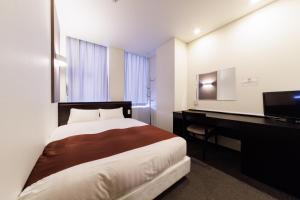 Tempat tidur dalam kamar di Hotel Fosse Himeji
