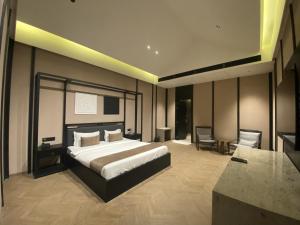 a hotel room with a bed and a desk at Radhe Upavan Resort in Ahmedabad +68 photos