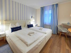 Ein Bett oder Betten in einem Zimmer der Unterkunft Dünenpark Binz - WG 73 "Strandläufer" mit Terrasse