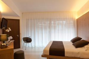 a bedroom with a bed and a window at Eolian Milazzo Hotel in Milazzo