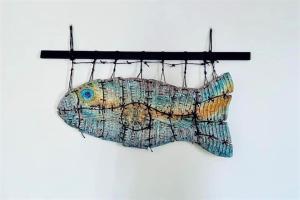 a fish decoration hanging from a hook at Casa Rosa - Santa Marina in Santa Marina Salina +21 photos