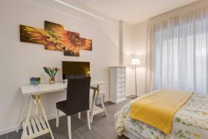 a bedroom with a desk and a bed and a desk and a chair at AV Domus Vatican St.Peter B&B in Rome