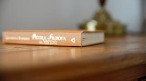 a book sitting on top of a wooden table at Combo Rooms in Garna dʼAlpago