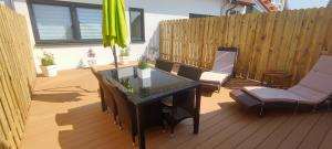 a patio with a table and chairs and a fence at Balilounge in Haßloch