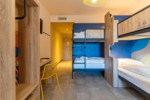 a room with two bunk beds and a desk at MEININGER Marseille Centre la Joliette in Marseille