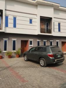 a black car parked in front of a building at DELIGHTFUL ! 3 BEDROOM TERRACE DUPLEX EN-SUITE ORCHID RD LEKKI AIRCON WiFi in Lagos