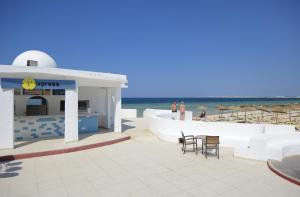 a kiosk on the beach with a view of the ocean at One Resort Aqua Park in Monastir