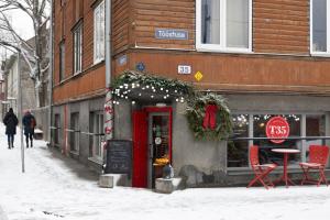 a store with a christmas wreath on the front of a building at Like Home Apartments Salme 31 in Tallinn