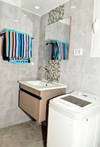 a bathroom with a sink and a mirror at BUNGALOW El HOUDA in Hammamet