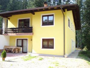 a small yellow house with a table in front of it at Haus ter Stege in Annaberg im Lammertal