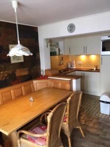 a kitchen with a wooden table and two chairs at Haus ter Stege in Annaberg im Lammertal