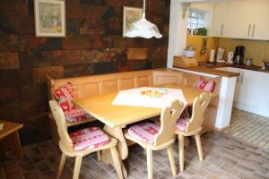 a kitchen with a wooden table and chairs in a room at Haus ter Stege in Annaberg im Lammertal