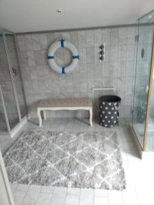 a bathroom with a bench in the corner of a shower at Ferienwohnung Christine in Jever +39 photos