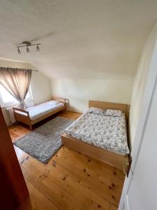 a bedroom with two beds and a window at Kuća za odmor IVKOVIĆ in Kupres