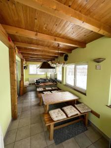 a kitchen with wooden ceilings and tables in a room at Kuća za odmor IVKOVIĆ in Kupres